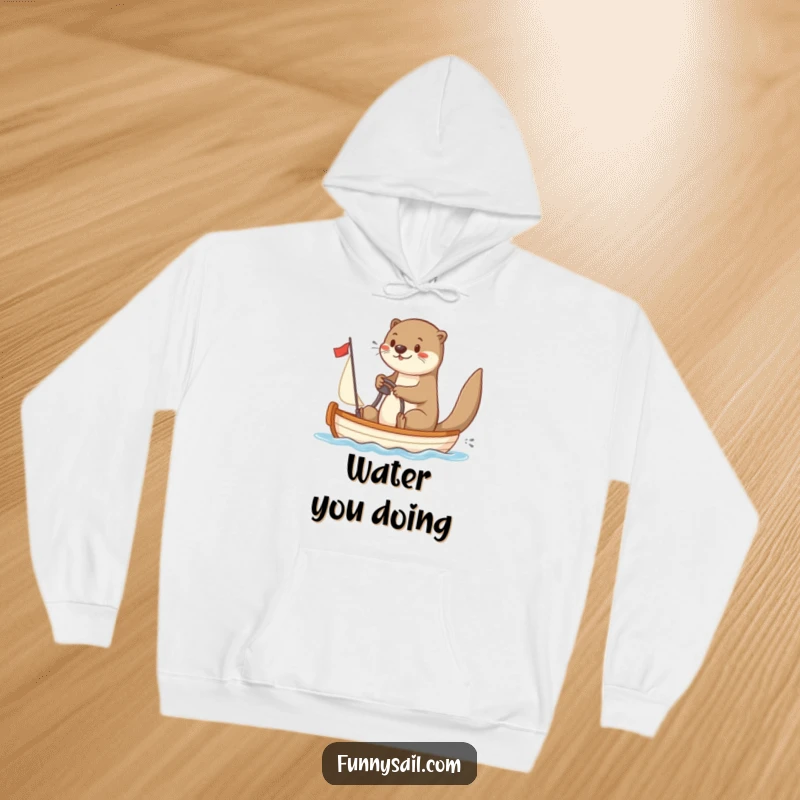 Funny Otter Sailor Hoodie: A warm and comfortable hoodie featuring a playful otter steering a sailboat, perfect for nautical humor.